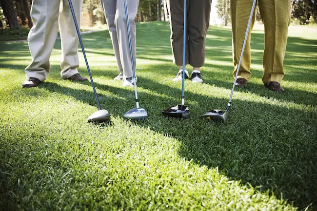 Closeup-of-the-feet-of-four-golfers-and-the-head-o-2022-03-04-02-11-28-utc