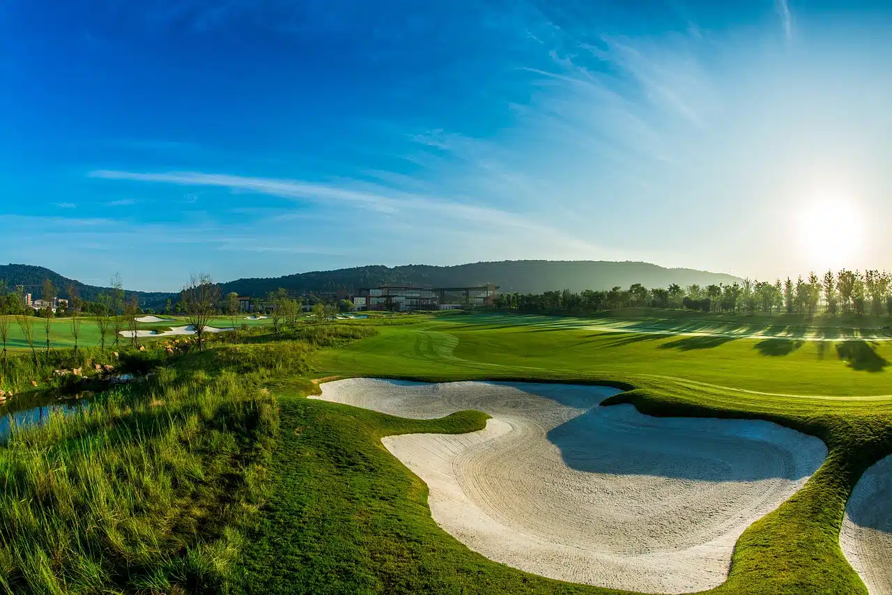 wide angle view of golf course with blue sky