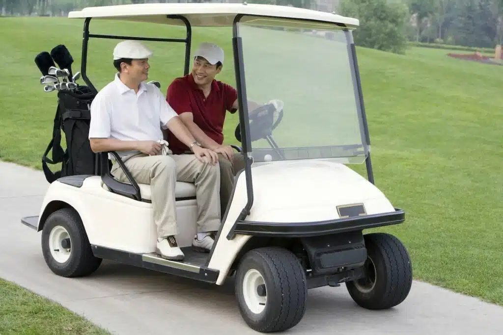 Two Chinese golfers in the golf cart